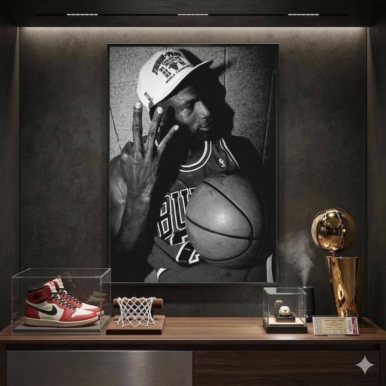 a framed black and white photograph of a basketball player, along with a trophy, a basketball, and a pair of sneakers on a wooden shelf.