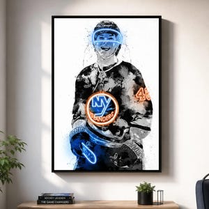 May include: A vertical wall art print featuring a stylized watercolor illustration of a hockey player wearing a New York Islanders jersey with the number 46. The player has a glowing blue visor and the team logo is highlighted in bright orange and blue.