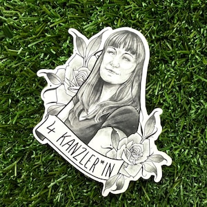 May include: Black and white illustration of a woman with long hair, wearing a shirt and looking at the viewer. The illustration is surrounded by roses and leaves. The text "4 KANZLER*IN" is on a banner below the woman.