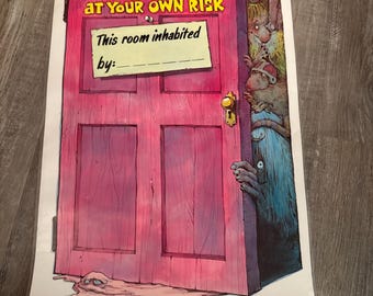 May include: A cartoon illustration of a pink door with the text "ENTER AT YOUR OWN RISK". The door is slightly ajar, revealing a monster peering out. A sign on the door reads "This room inhabited by:" with a blank space for a name.