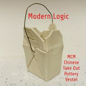 May include: A white ceramic take-out container with a wire handle. The container is shaped like a traditional Chinese take-out box. The text "Modern Logic" is written above the container. The text "MCM Chinese Take Out Pottery Vessel" is written below the container.