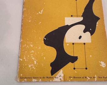 May include: A vintage book titled "What is Modern Painting?" with a yellow cover and black abstract art. The book is a revised edition from the Museum of Modern Art in New York.