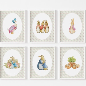 May include: Six framed watercolor prints featuring illustrations of Beatrix Potter characters. The prints include a duck, rabbits, and carrots, set against a floral background. The artwork is displayed in white frames.