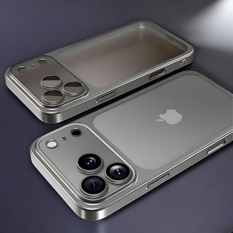 May include: Two silver-colored phone cases. The cases have a transparent back with the Apple logo and a silver frame. Each case has a camera module with three lenses. The cases are designed to protect the phone.