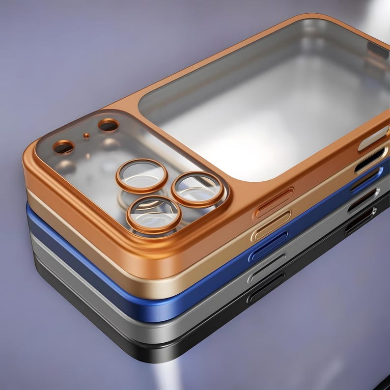 May include: A stack of phone cases in various colors: bronze, gold, blue, gray, and black. Each case has a clear, transparent section for the phone screen and circular cutouts for the camera lenses. The cases are stacked on a gradient purple background.