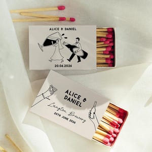 May include: Two open matchboxes with pink-tipped matches, featuring black and white illustrations and text. One box reads "Alice & Daniel" and "20.06.2026". The other box reads "Alice & Daniel, Langton Brewery, 20th June 2026".