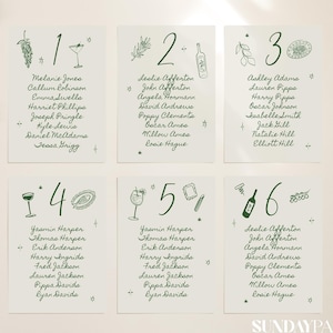 May include: Six white table cards with green ink, each featuring a number, illustrations, and guest names. The cards are arranged on a light background with dried flowers. The text "SUNDAYPAPER WORKS" is at the bottom.