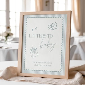 May include: A framed sign with the text "LETTERS TO baby" in a light blue script font. The sign has a light blue striped background and decorative border. The frame is made of light-coloured wood. The text "FROM THE PEOPLE WHO LOVE YOU THE MOST" is also included.