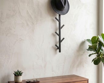 May include: A dark gray felt fedora hat hanging on a black vertical wall-mounted coat rack with six angled hooks. The rack is constructed with a central post and alternating branches, providing a functional storage solution for headwear.