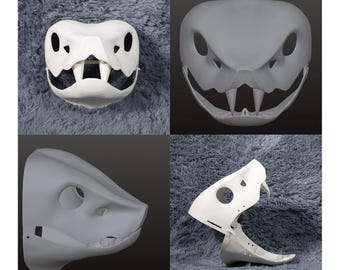 May include: Four-panel image of reptile skull masks. Two are white, and two are gray. The masks have large eye sockets, sharp teeth, and detailed bone structures. The masks are likely for costumes or artistic projects.