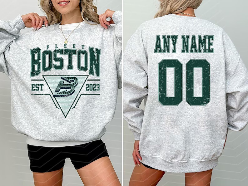 May include: A light gray sweatshirt with the word "BOSTON" in dark green block letters. Below the word "BOSTON" is a triangle with the letter "B" inside. The back of the sweatshirt has the words "ANY NAME" above the number "00".