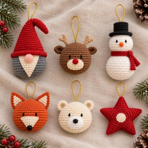 May include: Six crocheted Christmas ornaments featuring a gnome with a red hat, a brown reindeer with antlers, a snowman with a black hat and red scarf, an orange fox, a cream-colored bear, and a red star, each with a gold hanging loop.