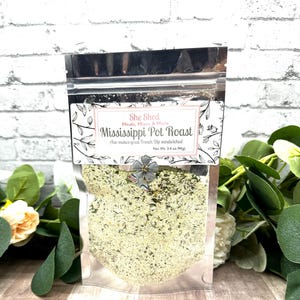 May include: A silver resealable pouch containing a green and white seasoning mix labeled "She Shed Meals, Mixes & More Mississippi Pot Roast Also makes great French Dip sandwiches! Net Wt. 3.4 oz (94g)"