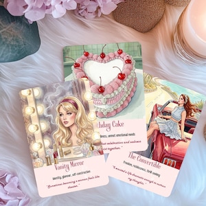 May include: Three rectangular oracle cards featuring illustrations of a vanity mirror with a blonde person, a heart-shaped cake with cherries, and a person in a red convertible car. Each card includes a title, keywords, and a quote in black text.