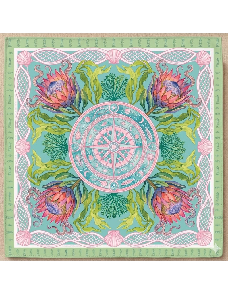May include: Square decorative art piece with a nautical theme. The design features a central compass rose in pink and teal, surrounded by stylized flowers, seaweed, and seashells. The border is a light green with lighthouse and shell motifs.