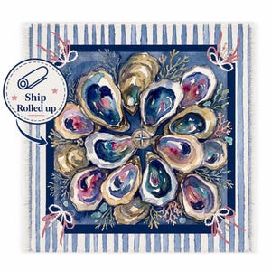 May include: A square textile featuring a watercolor illustration of oysters arranged in a circular pattern around a central compass rose. The design includes coral accents, pearl-like strings, and a blue and white striped border with frayed edges.