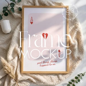 May include: A framed art print featuring a playing card design with the Ace of Hearts. The print has a light pink background and the text "good things always happen to me". The frame is made of light brown wood.