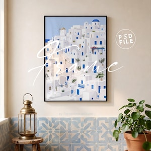 May include: A vertical black frame containing a digital illustration of white Mediterranean buildings with blue accents, a windmill, and potted plants. The image features the text PSD FILE and Frame MOCKUP.