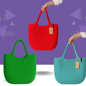 May include: Three crochet tote bags in red, green, and teal. Each bag has a rounded shape, sturdy handles, and a textured surface. The bags are held up by hands, and each has a small tag attached.