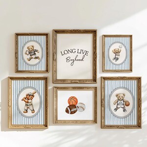 May include: A collection of framed vintage teddy bear prints. The prints feature a variety of teddy bears playing sports, along with an alphabet print and a print that says "Long Live Boyhood". The frames have a gold finish.