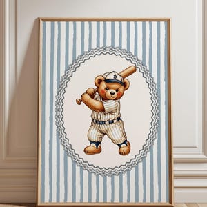 May include: A framed print featuring a teddy bear in a baseball uniform, holding a bat. The bear is in a white and blue pinstripe uniform and cap. The background has blue and white vertical stripes, and the print is framed in a wooden frame.