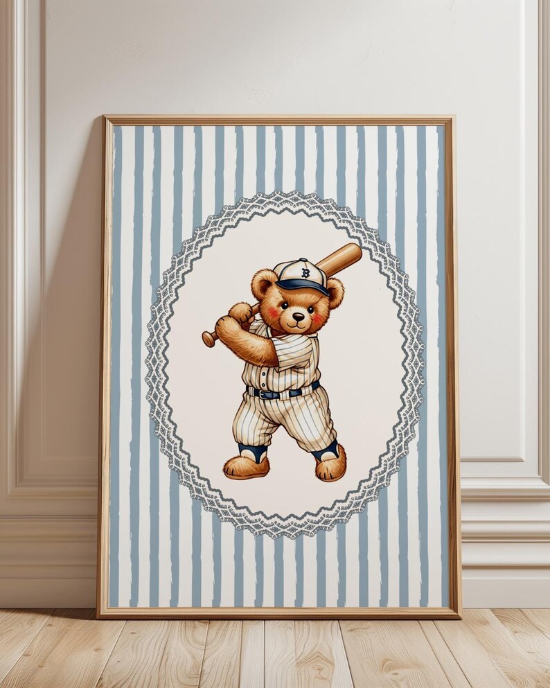 May include: A framed print featuring a teddy bear in a baseball uniform, holding a bat. The bear is in a white and blue pinstripe uniform and cap. The background has blue and white vertical stripes, and the print is framed in a wooden frame.