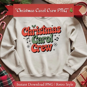 May include: Cream-colored sweatshirt with the text "Christmas Carol Crew" in red and green retro font. The design includes musical notes, snowflakes, and holly. A festive holiday-themed apparel item.