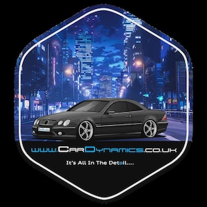 May include: A stylized image of a dark gray coupe car with silver rims, set against a nighttime cityscape with bright lights. The image is within a white-bordered, hexagonal shape. The text "www.CarDynamics.co.uk" and "It's All In The Detail...." are at the bottom.