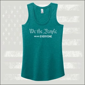 May include: Teal tank top with the text "We the People Means Everyone" in white lettering.