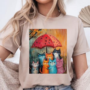 Whimsical Cat Tee, Cozy Cat Lover Shirt, Fun Animal Art T-Shirt, Rainy Day Apparel, Gift for Cat Moms, Unique Cat Parent Gift