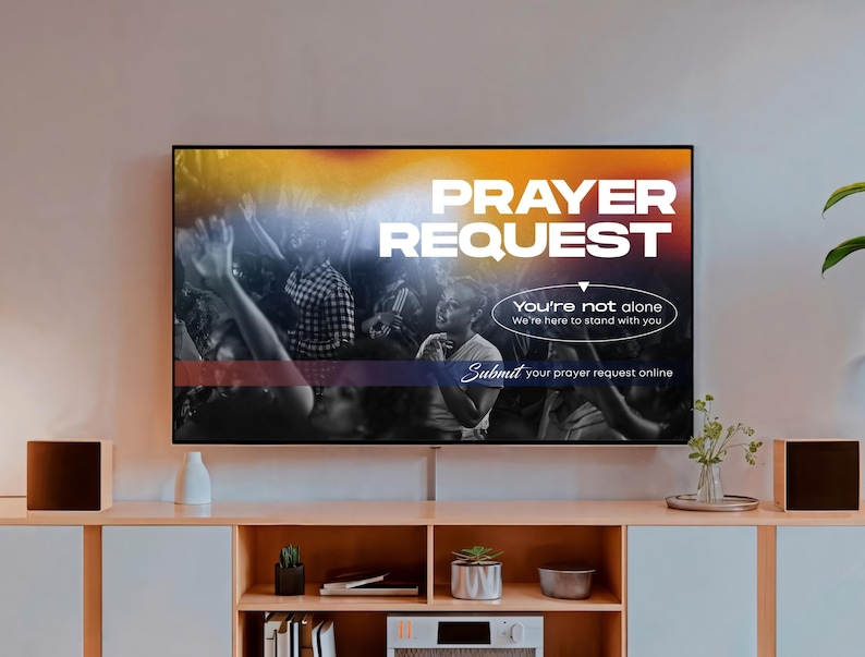 May include: A television screen displays the words "PRAYER REQUEST" in white against a colorful background. Below, it reads "You're not alone, We're here to stand with you." The text "Submit your prayer request online" is also visible.