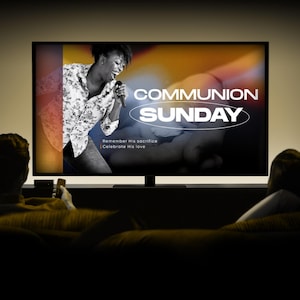 May include: A television screen displays the words "COMMUNION SUNDAY" in white, with a black and white image of a woman singing. The text "Remember His sacrifice | Celebrate His love" is also visible. Two people are sitting on a couch.