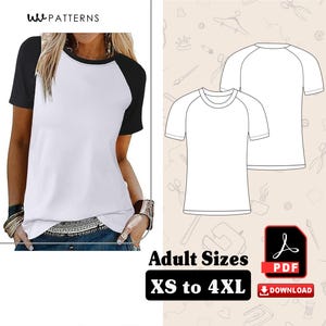 Könnte beinhalten: Ein weißes und schwarzes Raglan-Ärmel-T-Shirt. Das Shirt hat einen weißen Körper mit schwarzen Ärmeln und einem schwarzen Ausschnitt. Das Bild zeigt auch eine Strichzeichnung des Shirts und den Text "Adult Sizes XS to 4XL".