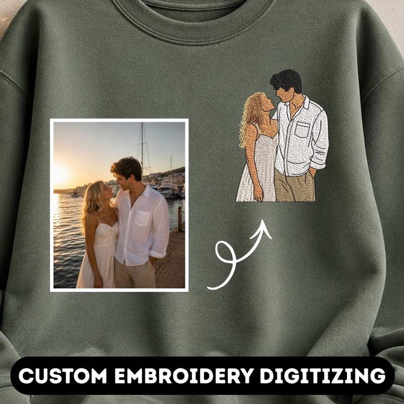May include: An olive green sweatshirt featuring a rectangular photograph of a couple standing by the water at sunset, alongside an embroidered line art version of the same couple, connected by a white arrow, with the text CUSTOM EMBROIDERY DIGITIZING.