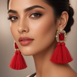 May include: Red tassel drop earrings featuring a rectangular red crystal set in a gold filigree frame. The text Elegant Red Tassel Drop Earrings – Gold Filigree & Crystal and the text Jewellery Portal are visible in the image.