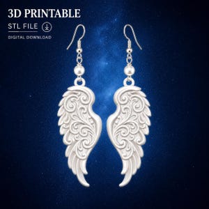 May include: A pair of silver-toned drop earrings featuring intricate filigree wing designs. Each earring hangs from a hook and includes a small white bead accent. The text 3D PRINTABLE STL FILE DIGITAL DOWNLOAD is visible in the upper left corner.