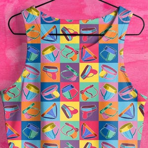 May include: A colorful tank top with a repeating pattern of underwear. The underwear is in various colors and designs, including red, blue, green, yellow, and black.