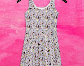 May include: A sleeveless gray dress with a pattern of sushi rolls and other Japanese food items. The dress has a fitted bodice and a flared skirt.