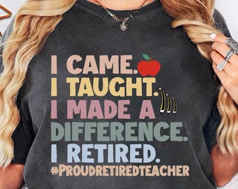 May include: Dark gray t-shirt with the text "I CAME. I TAUGHT. I MADE A DIFFERENCE. I RETIRED." and the hashtag #PROUDRETIREDTEACHER. The design includes a red apple and musical notes. The shirt is a Pepper color.