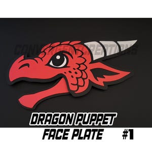 May include: A red dragon puppet face plate with black outlines and white accents. The dragon has a detailed design with a large eye and open mouth. The text "DRAGON PUPPET FACE PLATE #1" is displayed below the dragon.