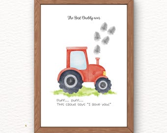 May include: A framed print featuring a red tractor illustration with black wheels and a blue window. The text "The Best Daddy ever" is above the tractor, with fingerprint clouds and the text "Duff... Duff... This cloud says 'I love you!'" below.