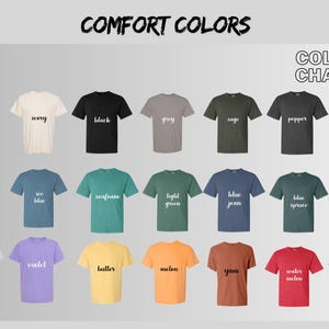 May include: A color chart displaying a variety of Comfort Colors t-shirts. The shirts are arranged in rows and columns, showcasing a range of colors including white, black, grey, and various shades of blue, green, yellow, orange, red, and purple. The text "COMFORT COLORS" and "COLOR CHART" are at the top.
