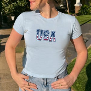 USA Baby Tee – 4th of July Crop Top for Women, Patriotic American Flag Shirt, Y2K Style Fitted Tee, Summer Festival Outfit