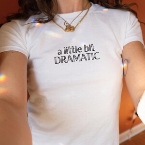 a little bit dramatic Baby Tee – Y2K Crop Top, Trendy Aesthetic Shirt, Coquette Girl Tee, Baddie Outfit, Fitted Baby Tee, Gift for Her