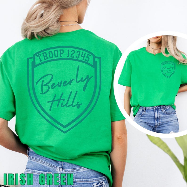 A woman wearing a green t-shirt with the text "Troop 12345 Beverly Hills" printed on it.