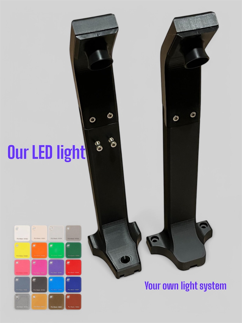 Op de afbeelding: Twee zwarte LED-armaturen met een rechthoekige basis en een cilindrische bovenkant. De tekst "Our LED light" en "Your own light system" zijn zichtbaar. Er wordt ook een kleurenpalet van verschillende kleuren getoond.