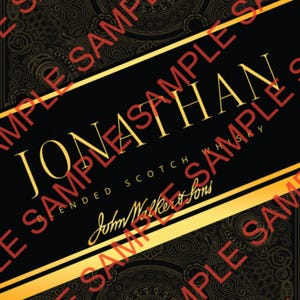 May include: Black and gold label for a bottle of blended scotch whisky, with the name "Jonathan" prominently displayed. Features a "Happy Birthday" ribbon, the number "25", and a figure of a man walking. Contains the text "Blended Scotch Whisky".