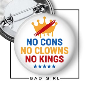 May include: A round white pin-back button featuring a yellow crown graphic with a red slash across it. The text reads NO CONS in blue, NO CLOWNS in yellow, and NO KINGS in red, followed by five blue stars. The back shows a metal pin mechanism.