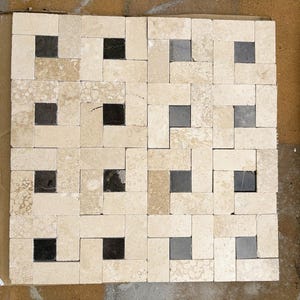 May include: A square tile mosaic sheet featuring a repeating basketweave pattern. The design consists of rectangular beige travertine tiles arranged around small, square black marble inserts, creating a high-contrast geometric grid layout.