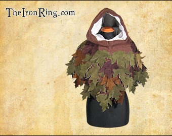 May include: A brown hooded cloak with a white lining and a design of green, brown, and purple leaves.